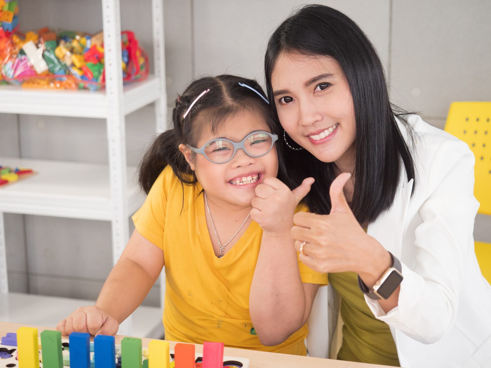 A teacher helping a young student in class.